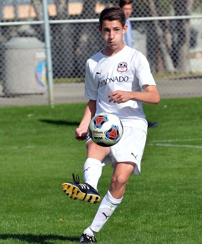 Soccer player running with the ball during a match