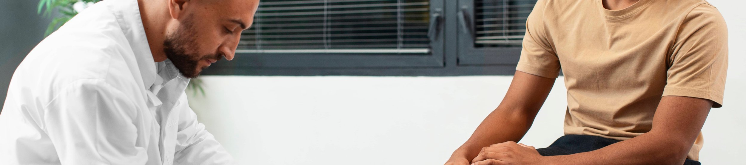 Physiotherapist consulting athlete in clinic