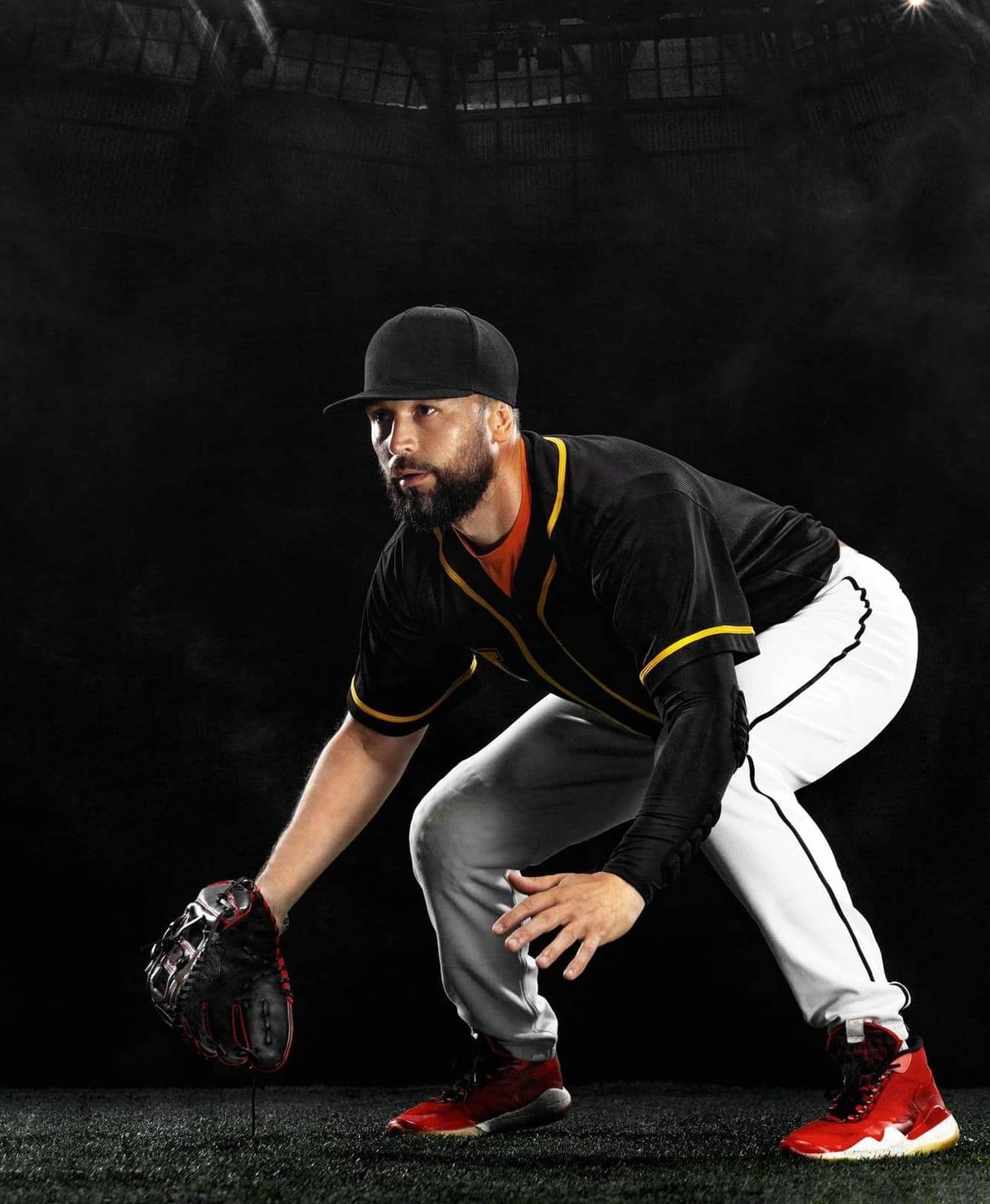 Athlete in activewear tying shoes on basketball court