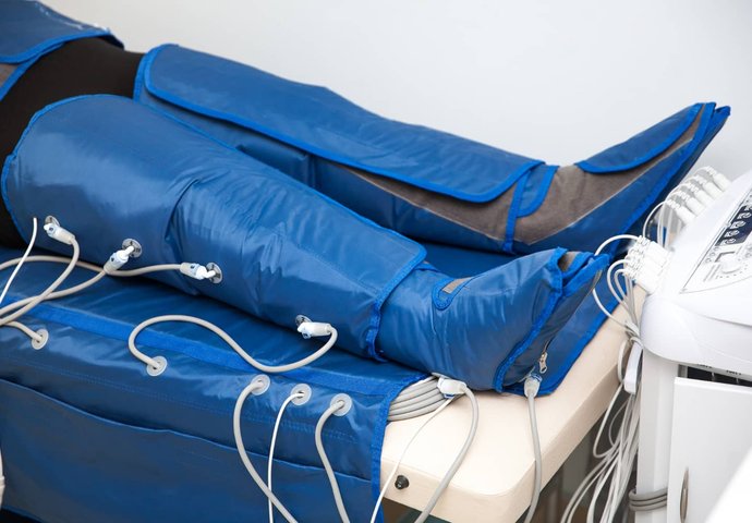 Man applying ankle brace on another person