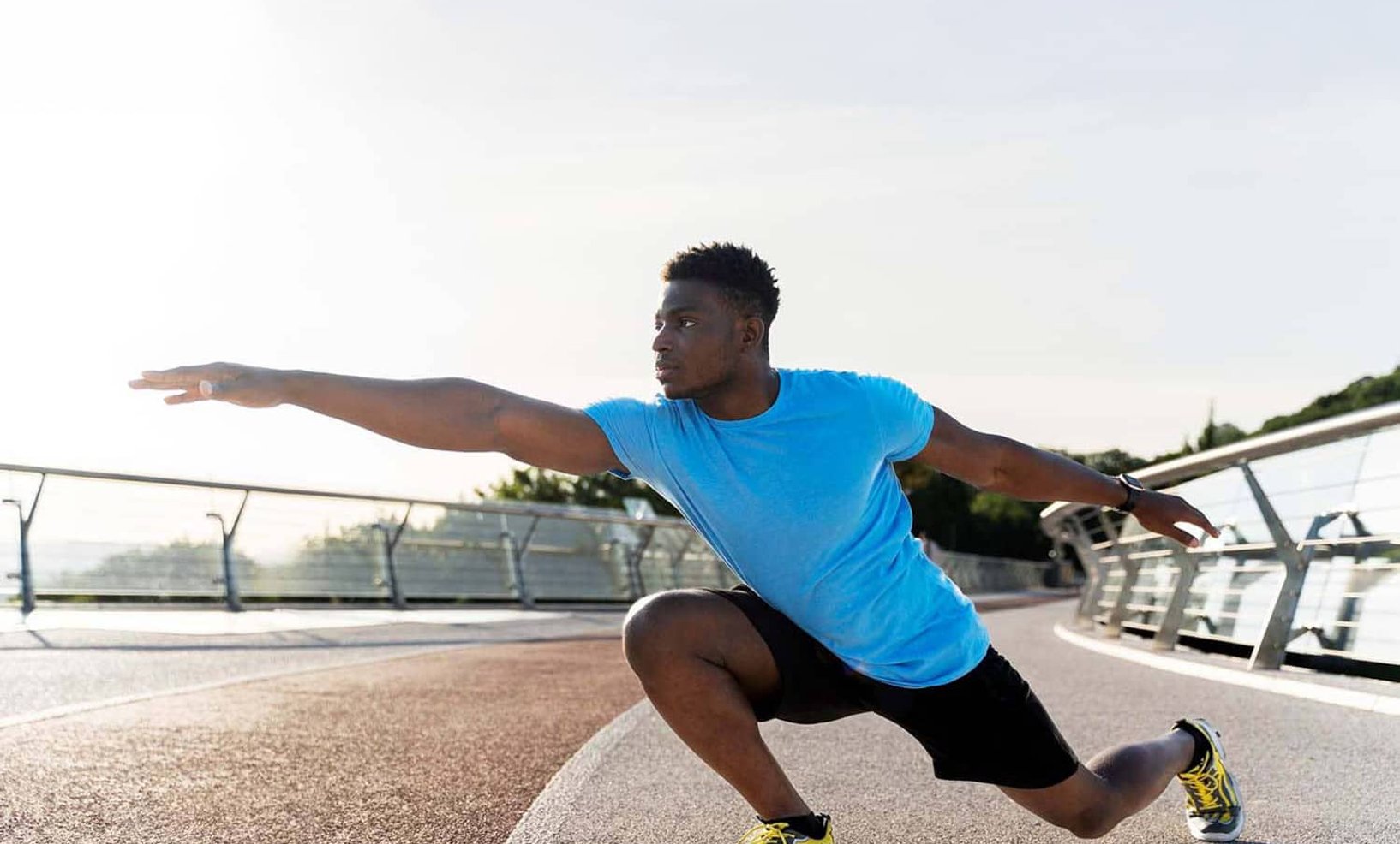 Athlete in activewear performing jump outdoors
